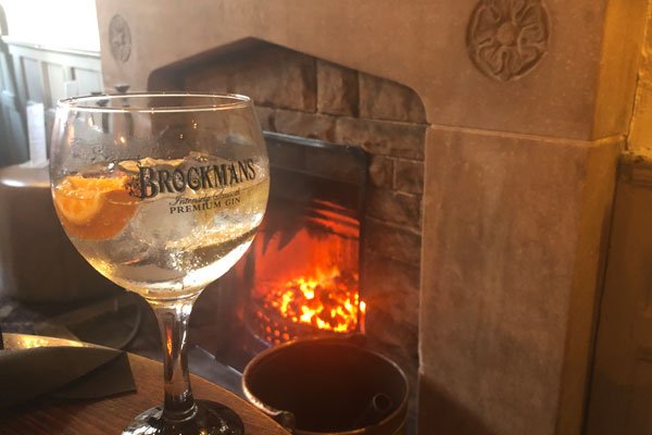 Glass of Gin next to a Fireplace in Nantwich